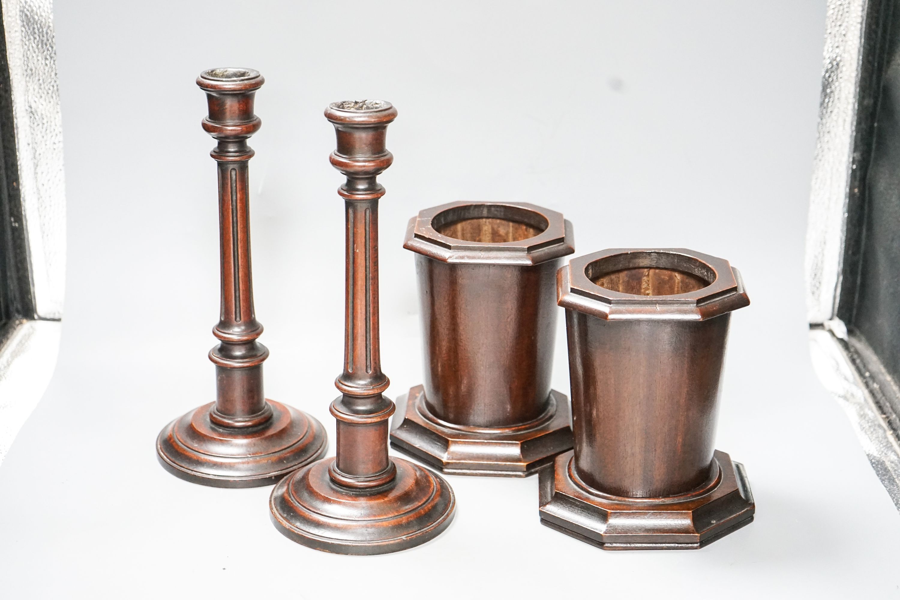 A pair of Victorian fluted mahogany candlesticks and a pair of mahogany spill vases 29cm